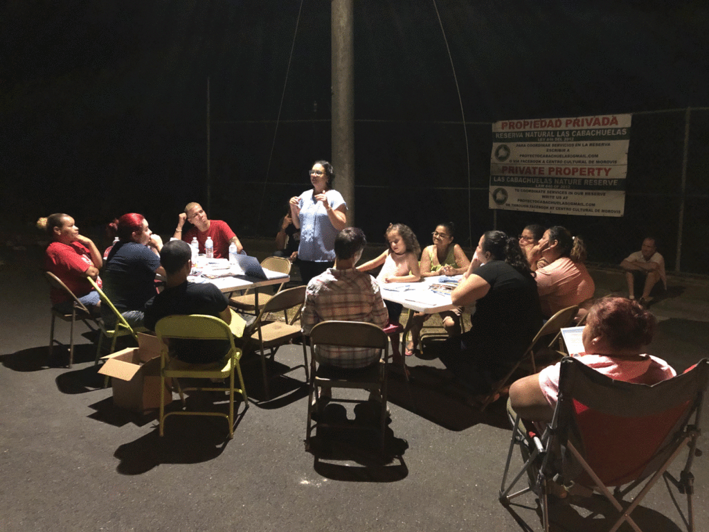 Group of people sitting in chairs at a meeting