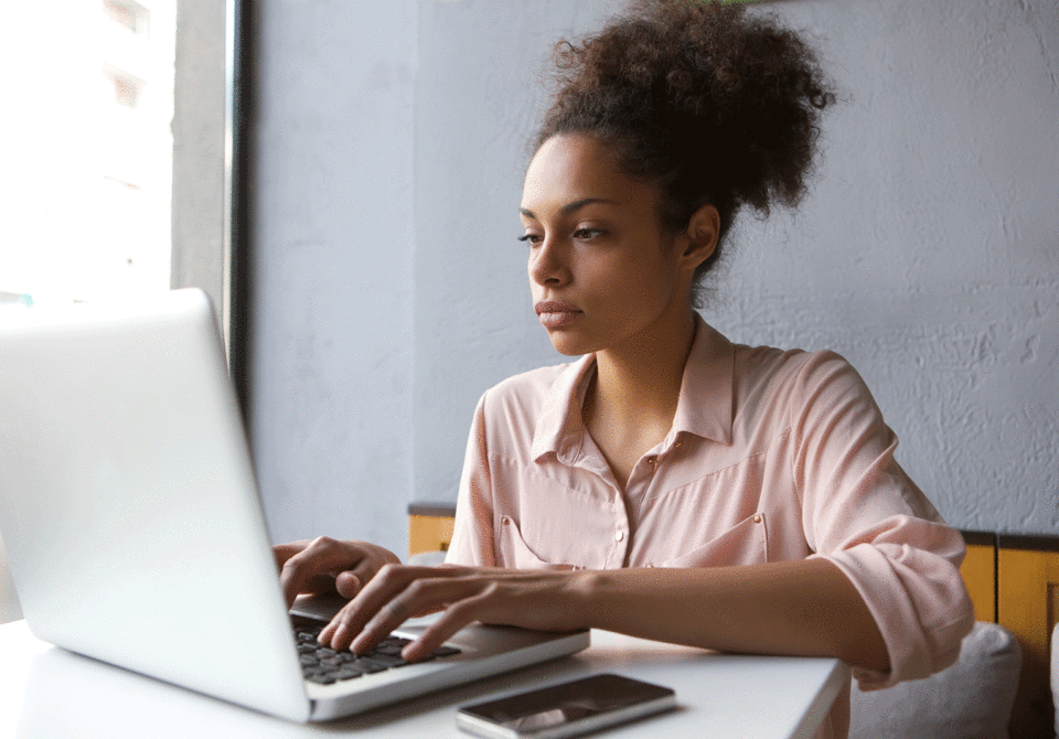 Woman typing on a laptop